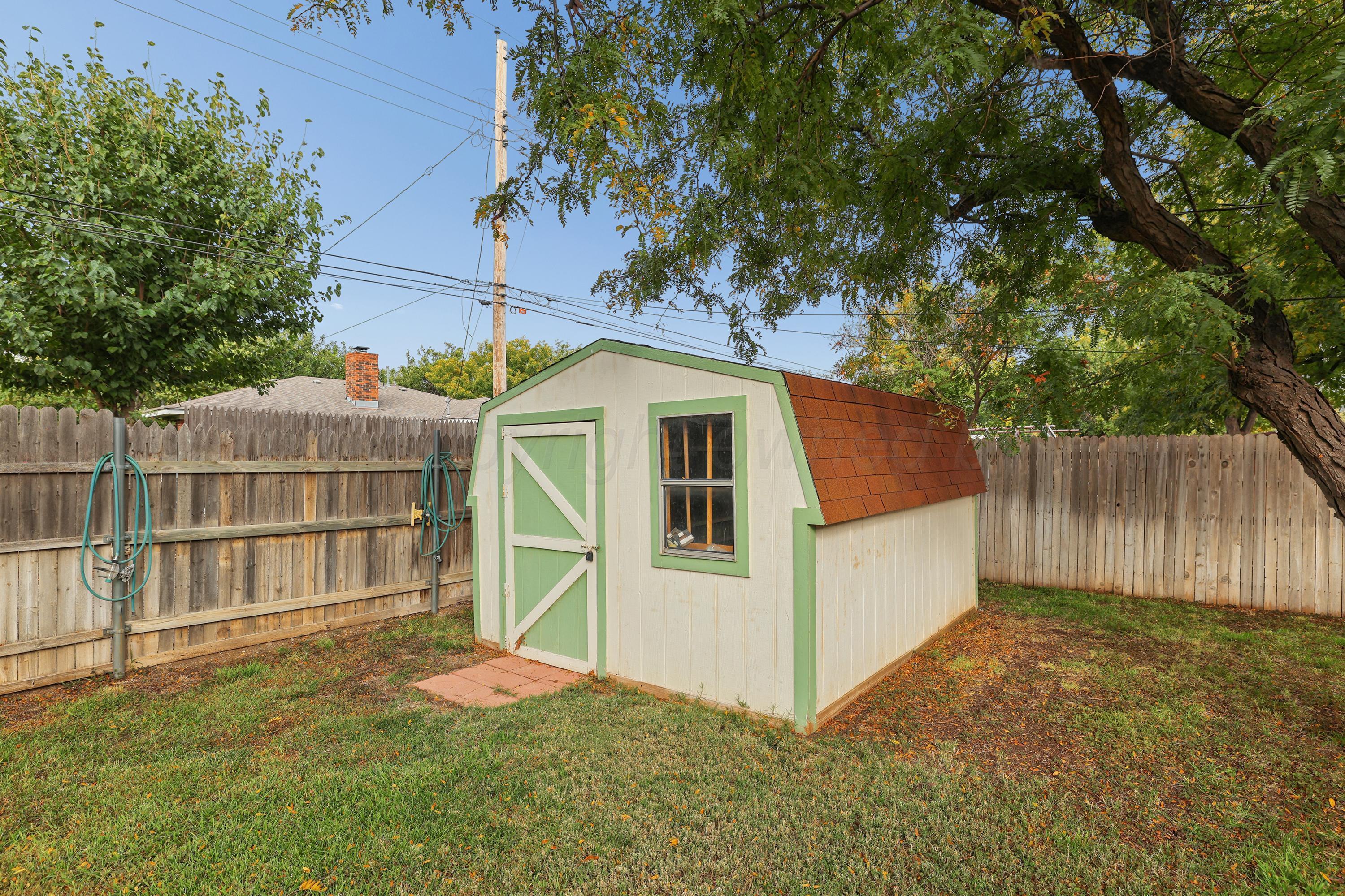 6108 Cornell Street Amarillo, TX 79109 - Photo 26 of 26 a view of a small house with wooden fence and large trees