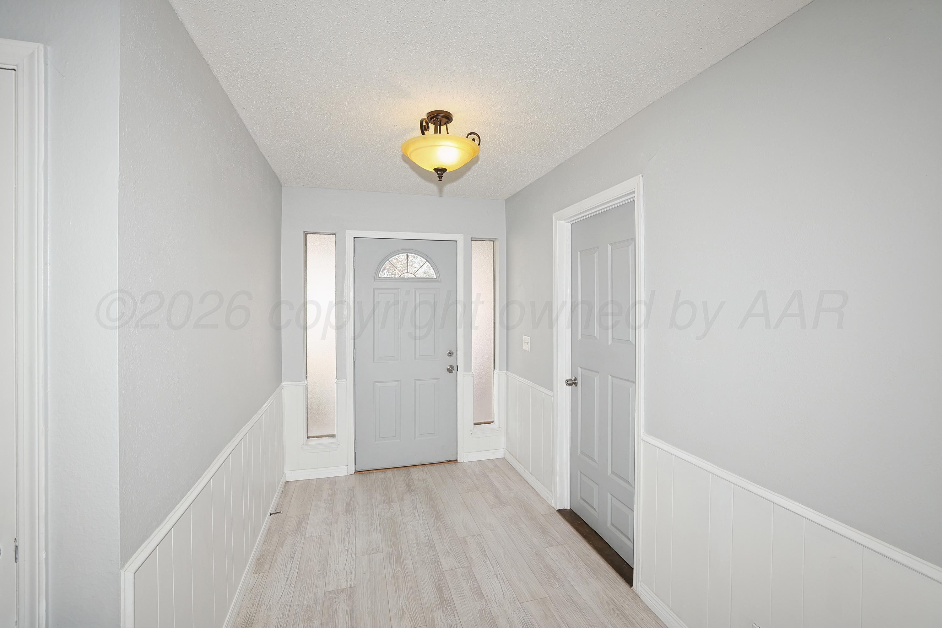 6108 Cornell Street Amarillo, TX 79109 - Photo 3 of 26 a view of a hallway with wooden shelves