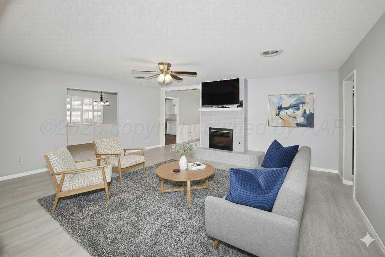 6108 Cornell Street Amarillo, TX 79109 - Photo 4 of 26 a living room with furniture a rug and a fireplace