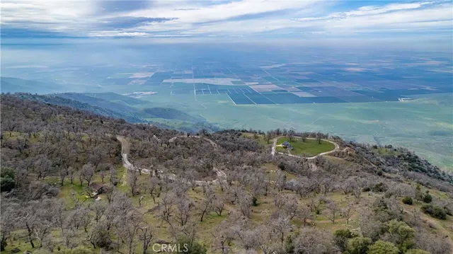 a view of a dry yard with wooden fence