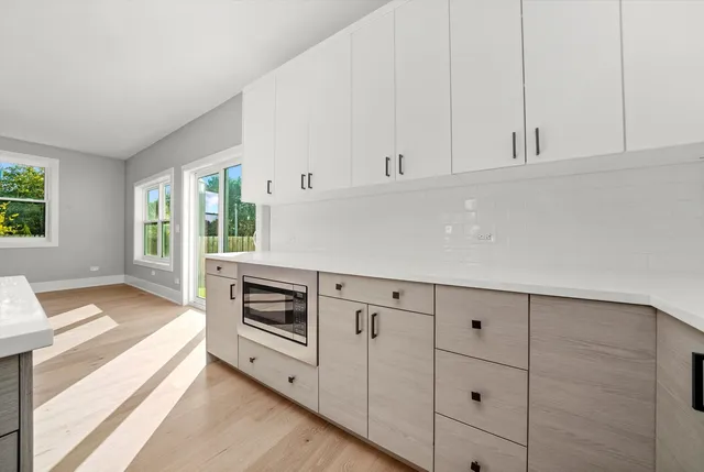 a utility room with cabinets washer and dryer