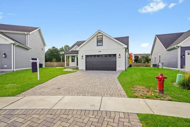 a front view of a house with yard and garage