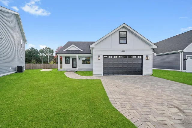 a front view of a house with garden