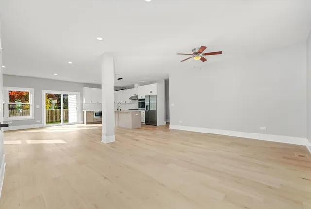 a view of a kitchen with a sink and a refrigerator