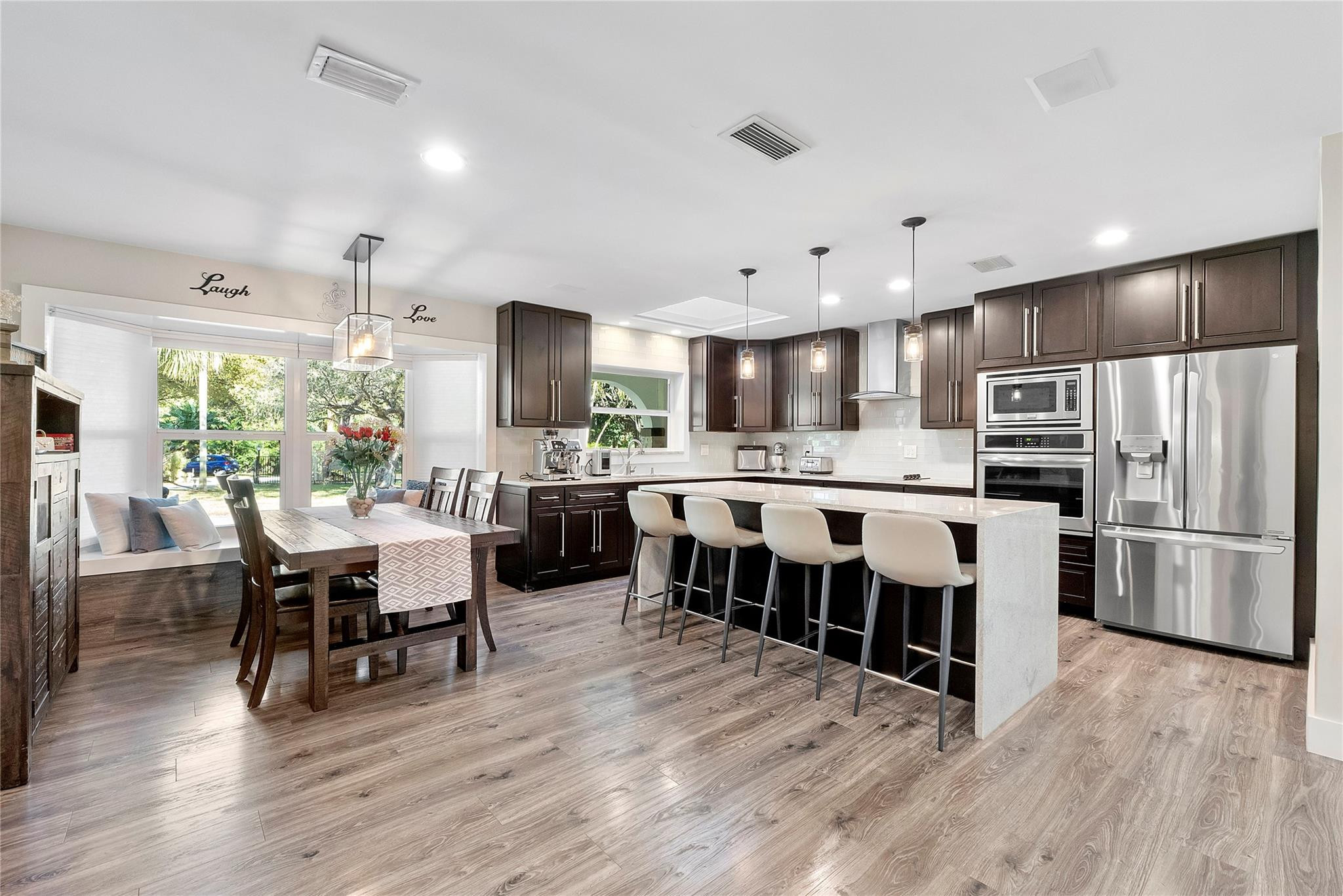 5351 Godfrey Road Parkland, FL 33067 - Photo 3 of 95 a large kitchen with a table and chairs