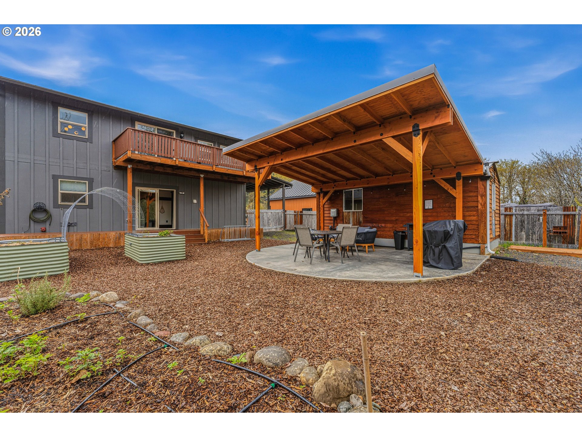 48367 Roaring Rapids Way Oakridge, OR 97463 - Photo 21 of 23 a view of a house with backyard porch and sitting area