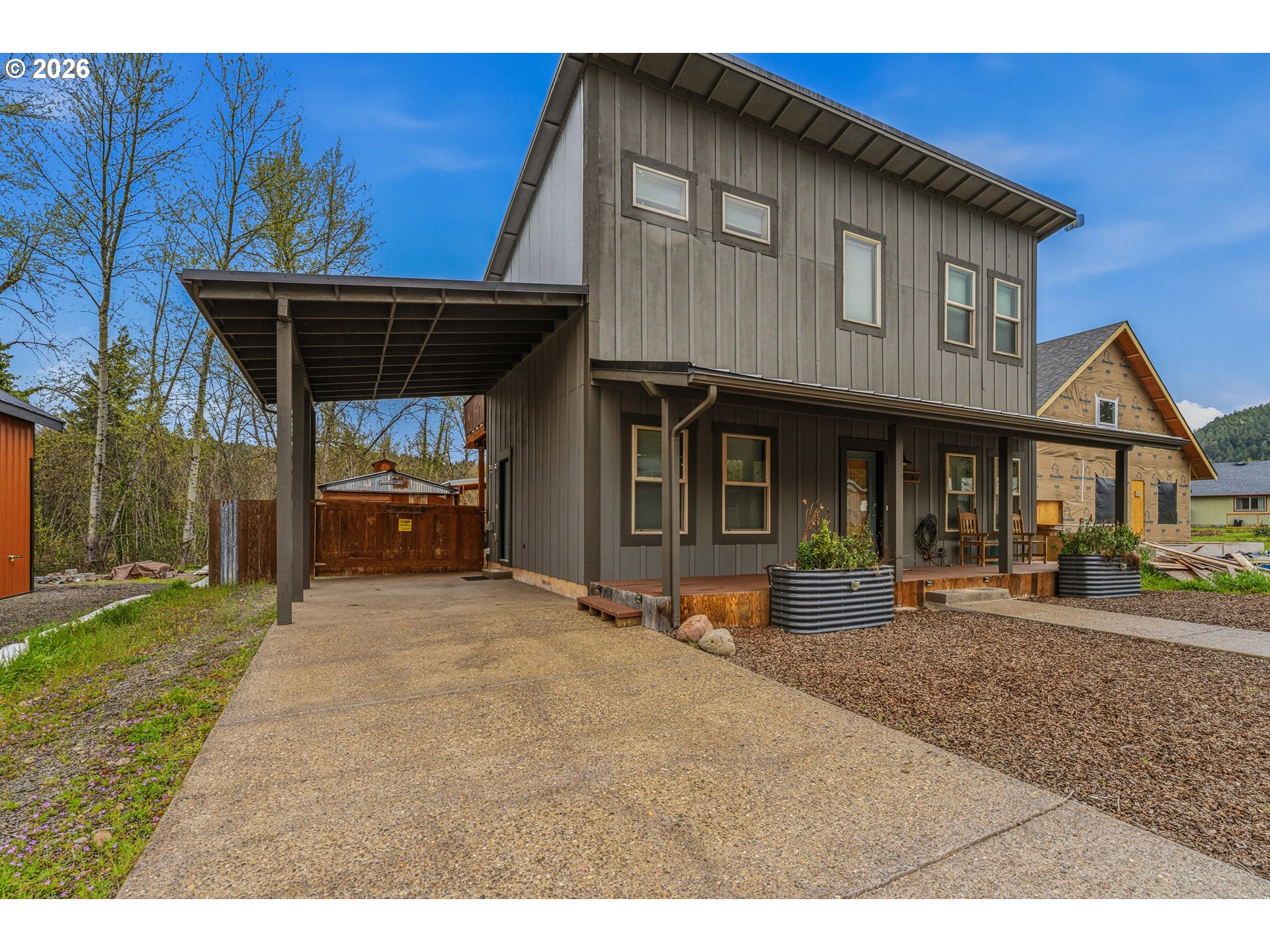 48367 Roaring Rapids Way Oakridge, OR 97463 - Photo 3 of 23 a front view of a house with garden