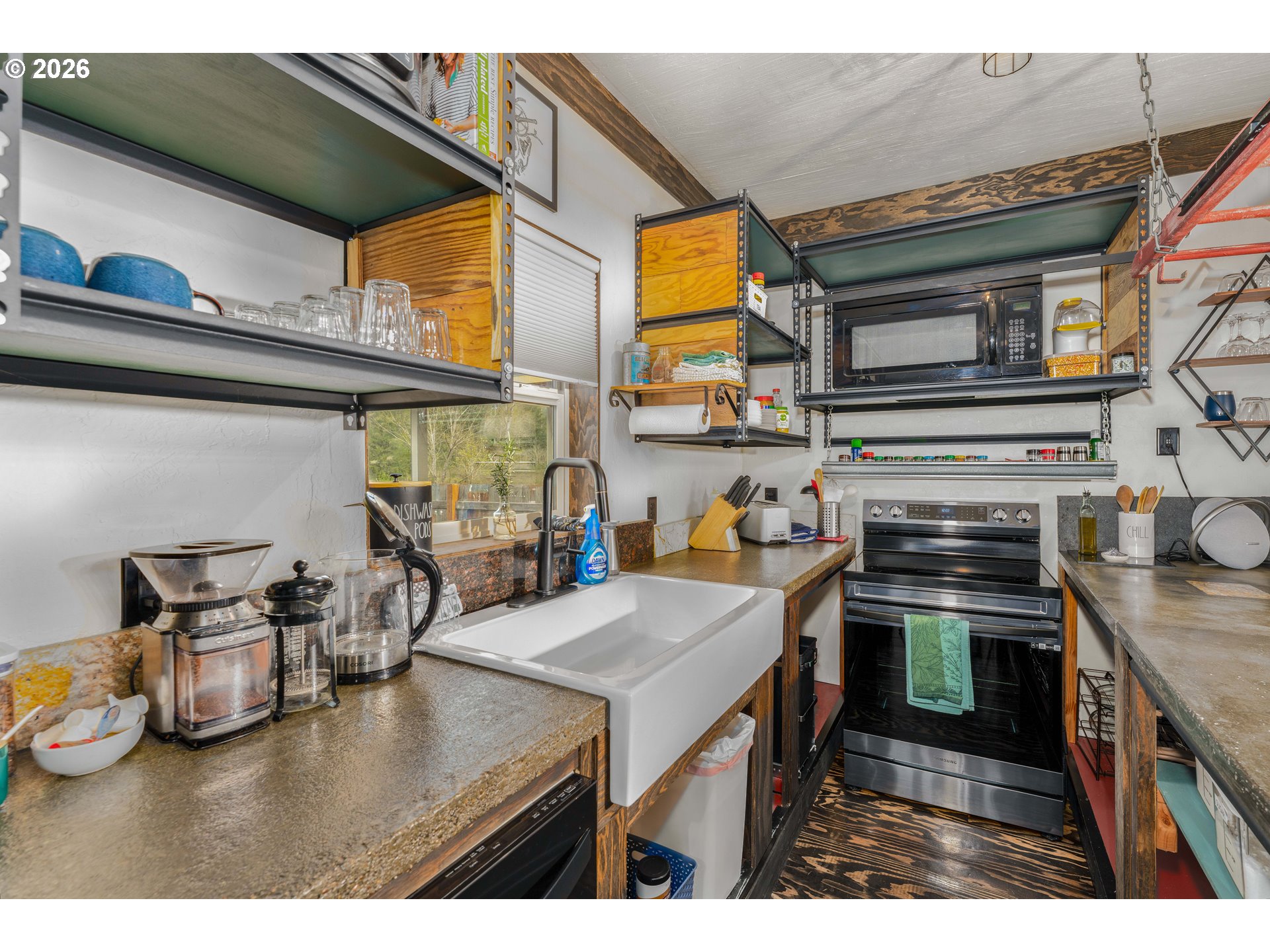 48367 Roaring Rapids Way Oakridge, OR 97463 - Photo 8 of 23 a kitchen with a stove and a microwave