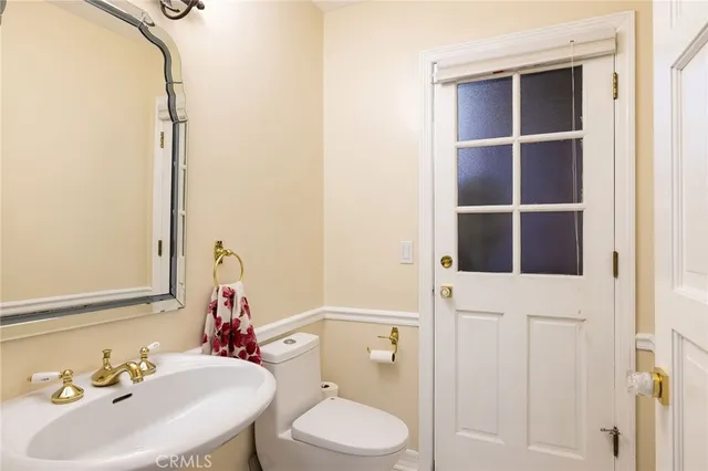 a bathroom with a granite countertop sink mirror shower and double