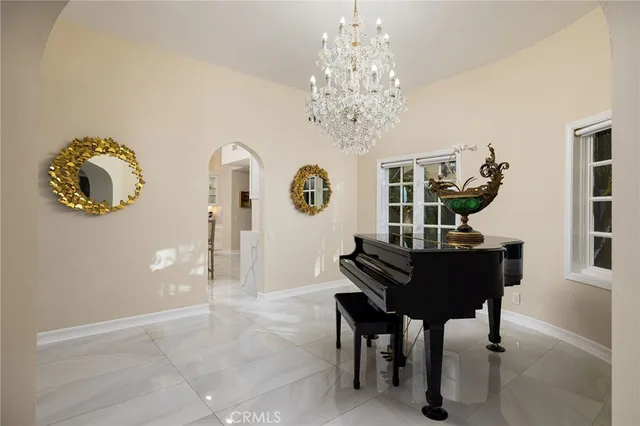 a view of a dining room with furniture and chandelier