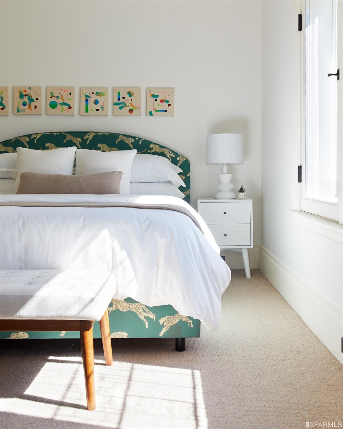 2440 Broadway San Francisco, CA 94115 - Photo 17 of 39 a bed sitting in a bedroom and painting on the wall