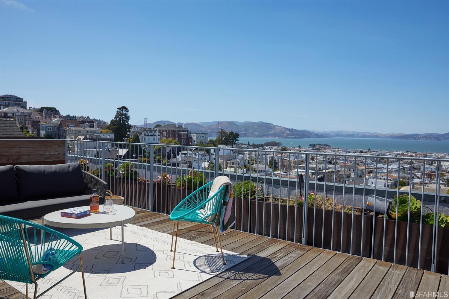 2440 Broadway San Francisco, CA 94115 - Photo 27 of 39 a balcony with wooden floor table and chairs