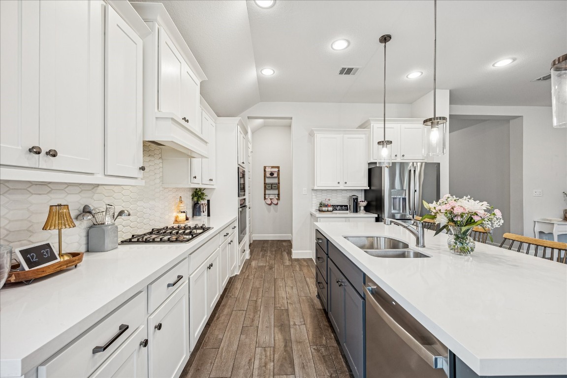 4527 Peloton Road Rosharon, TX 77583 - Photo 11 of 30 a kitchen with kitchen island white cabinets and stainless steel appliances