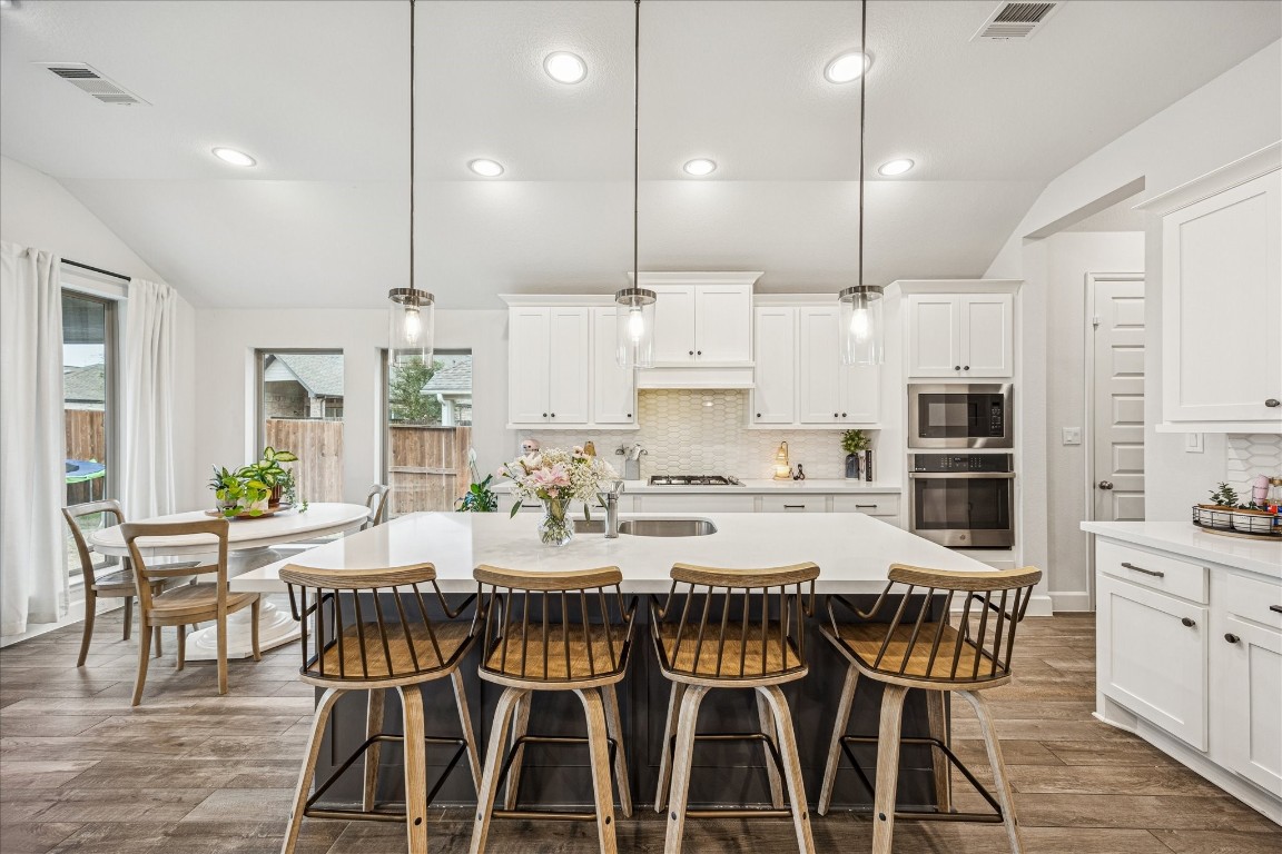 4527 Peloton Road Rosharon, TX 77583 - Photo 12 of 30 a view of a dining room and kitchen with a table chairs and barbeque oven