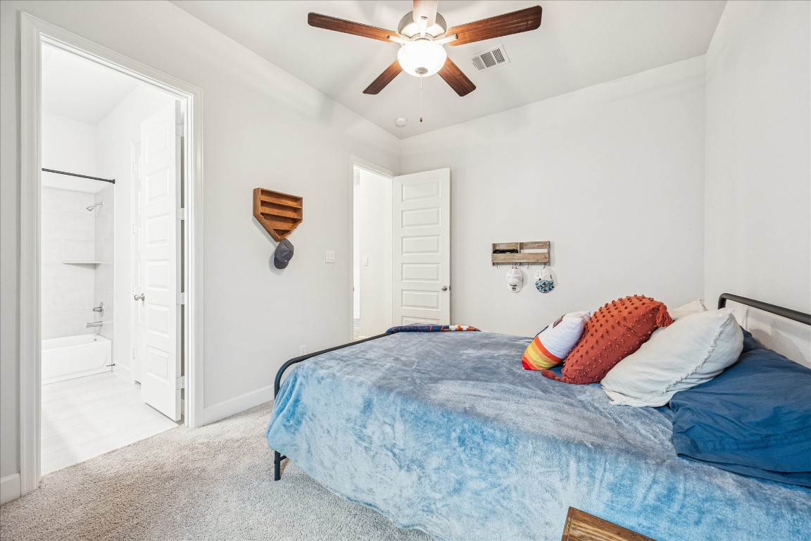 4527 Peloton Road Rosharon, TX 77583 - Photo 23 of 30 a bedroom with a bed and ceiling fan