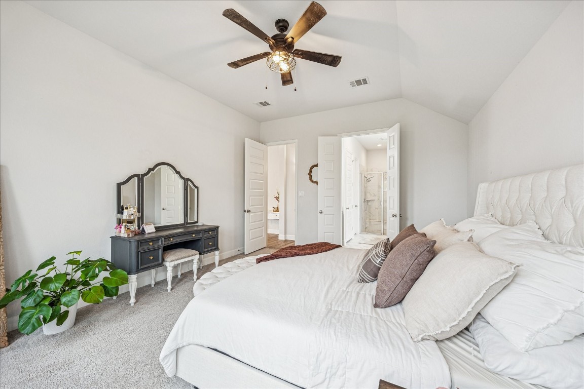 4527 Peloton Road Rosharon, TX 77583 - Photo 4 of 30 a bedroom with a bed table chair and a chandelier