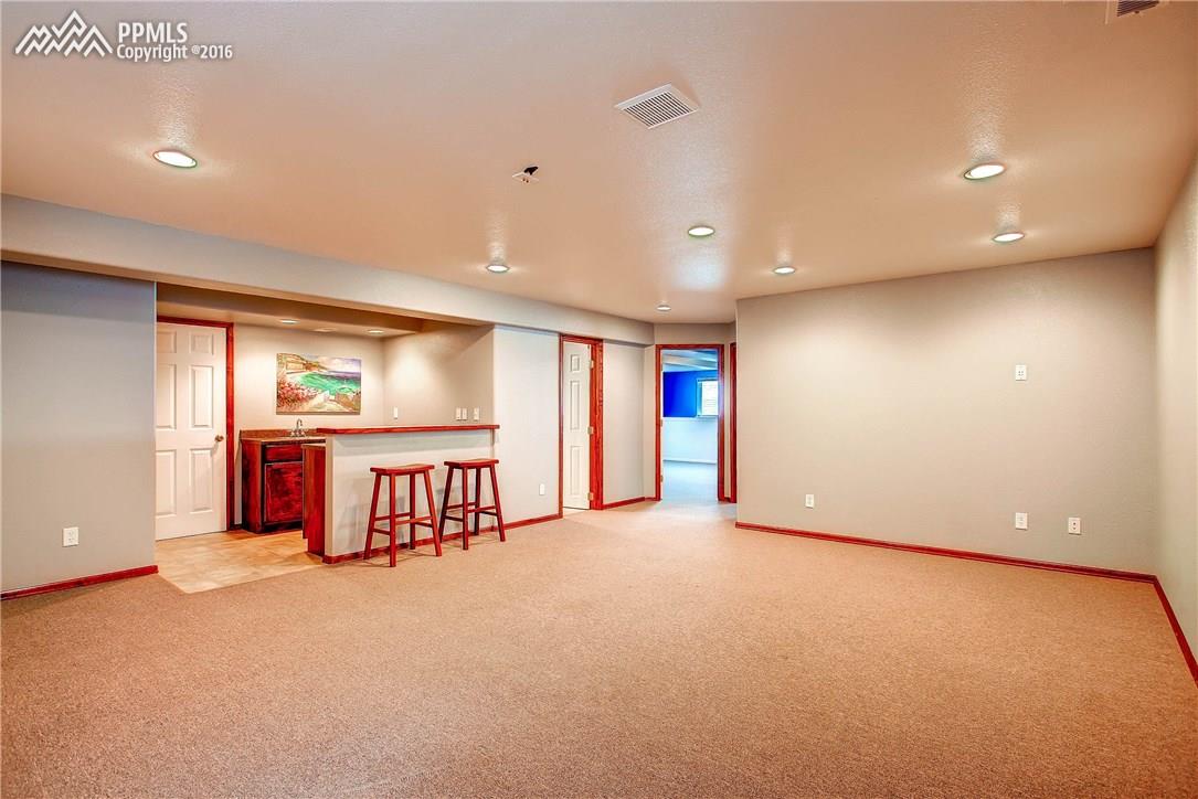12330 Motley Road Peyton, CO 80831 - Photo 18 of 27 The Rec Room in the basement would make a great space for hosting poker night or just kicking back for movie night!