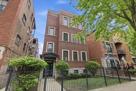 front view of a brick house with a yard