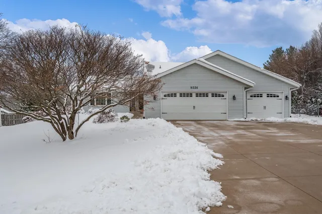 a view of large house with a large space covered with snow in front of it