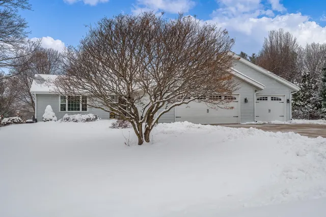 a view of a house with a snow in the yard