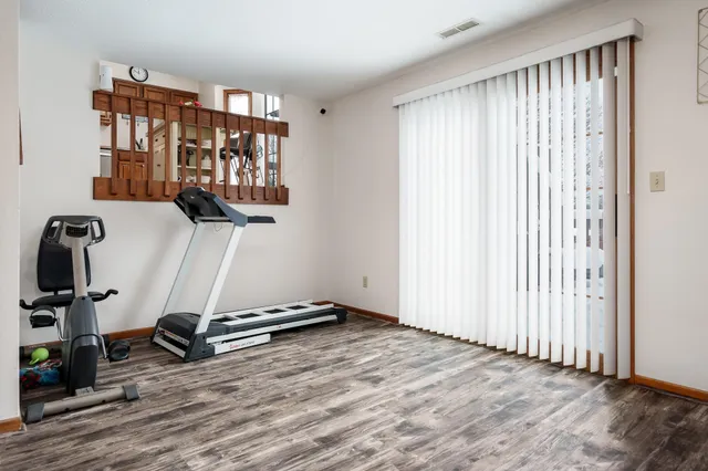 a view of a hallway view with wooden floor and bedroom view