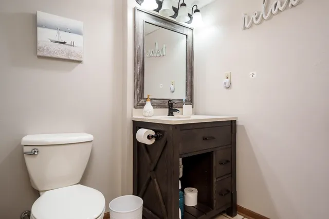 a bedroom with a bed and painting on the wall