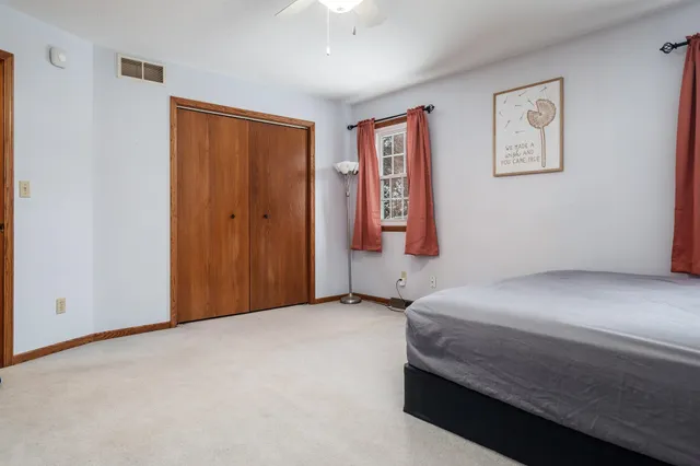 a bathroom with a sink a toilet a mirror and shower curtain