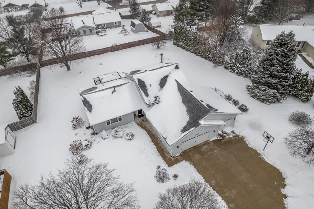 a view of a house with a snow in the yard