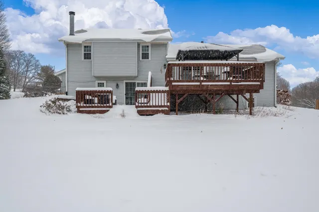 a view of porch with a table and chairs