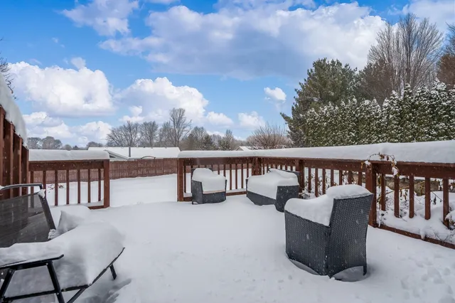 a roof deck with a couch and potted plants