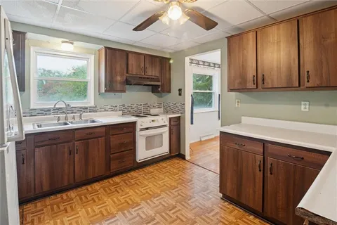 a kitchen with stainless steel appliances sink cabinets and window