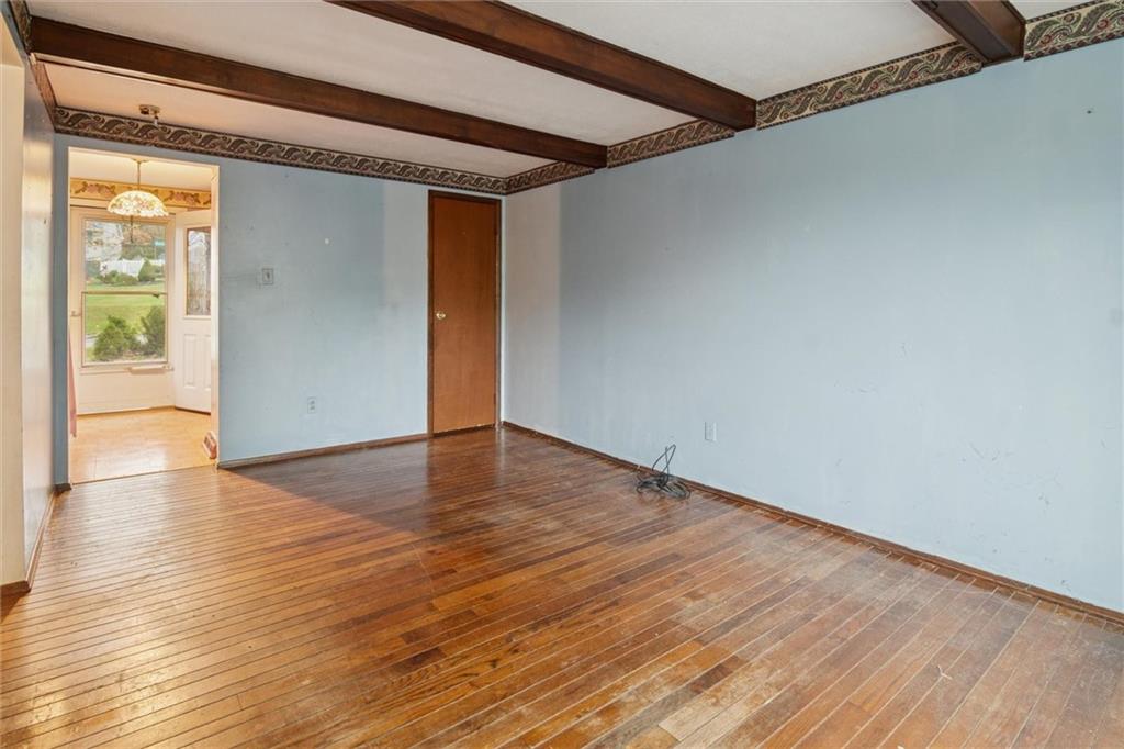 412 Church Road Bethel Park, PA 15102 - Photo 12 of 37 a view of an empty room with wooden floor and a window