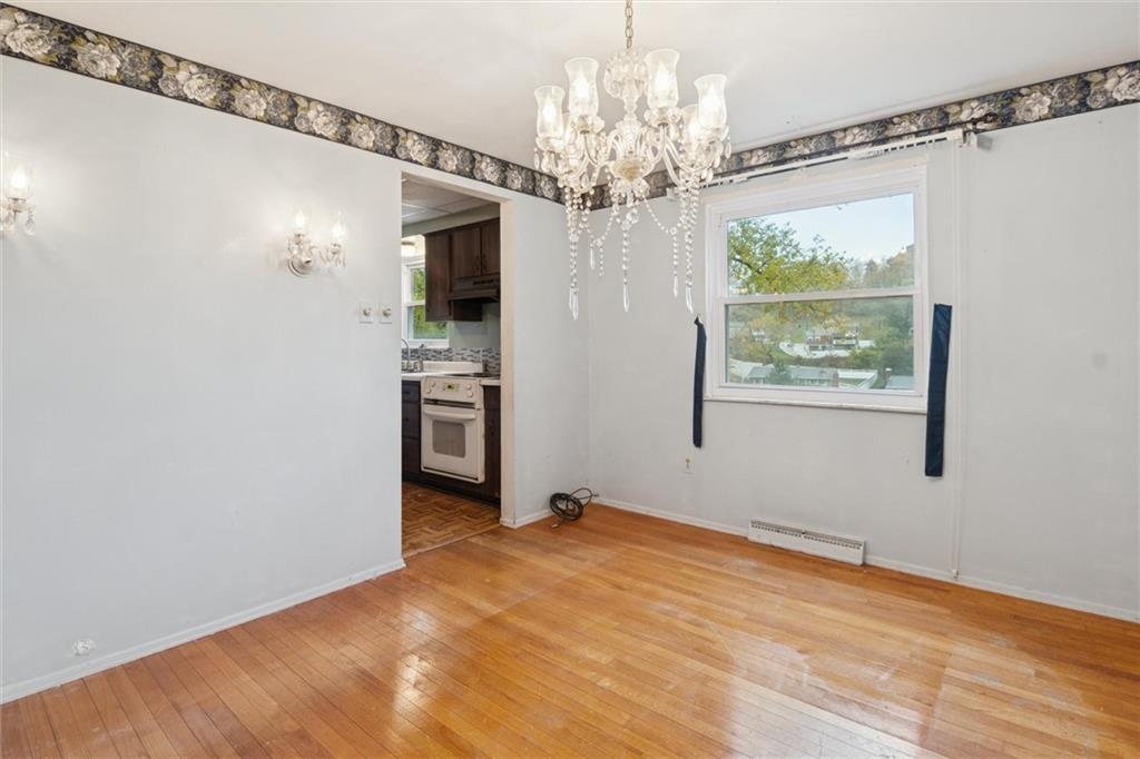 412 Church Road Bethel Park, PA 15102 - Photo 15 of 37 a view of a big room with windows and chandelier