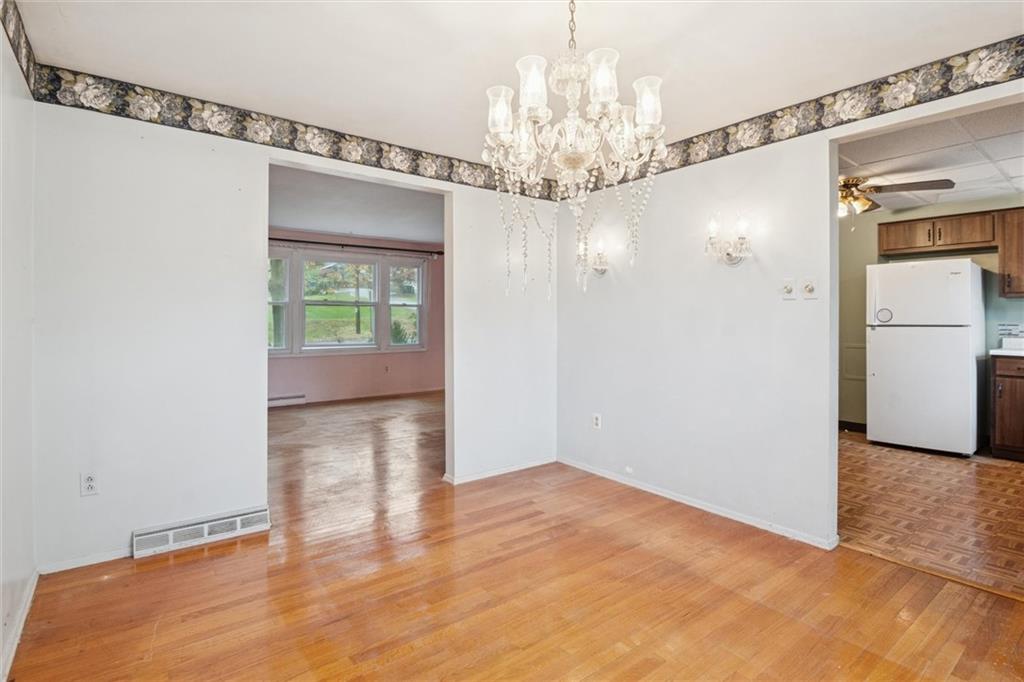 412 Church Road Bethel Park, PA 15102 - Photo 16 of 37 a view of a livingroom with a chandelier fan and windows