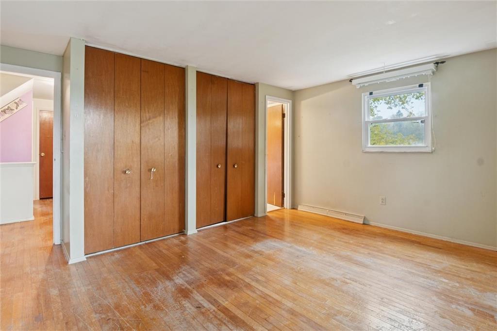 412 Church Road Bethel Park, PA 15102 - Photo 20 of 37 a view of an empty room with wooden floor and a window