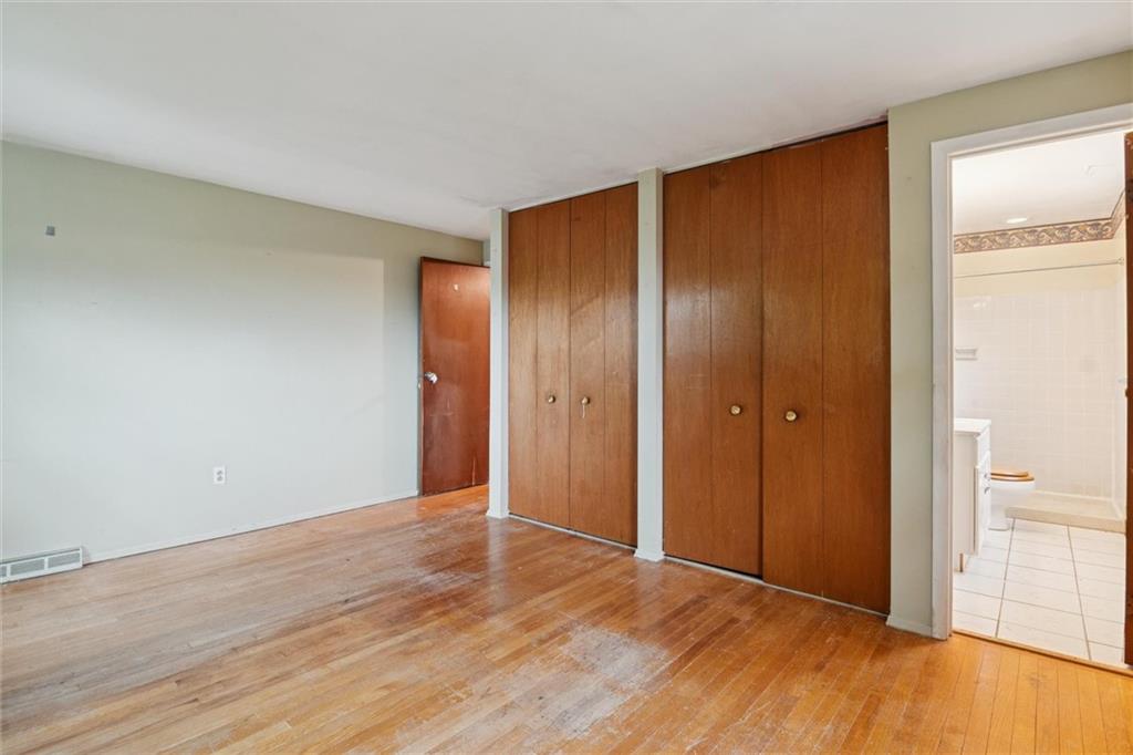 412 Church Road Bethel Park, PA 15102 - Photo 21 of 37 a view of an empty room with wooden floor and a window