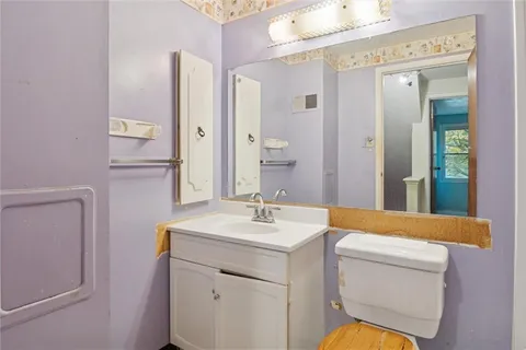 a bathroom with a sink a toilet and a mirror