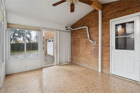 a view of a porch with wooden floor and front door