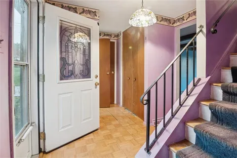 a view of an entryway with wooden floor and stairs