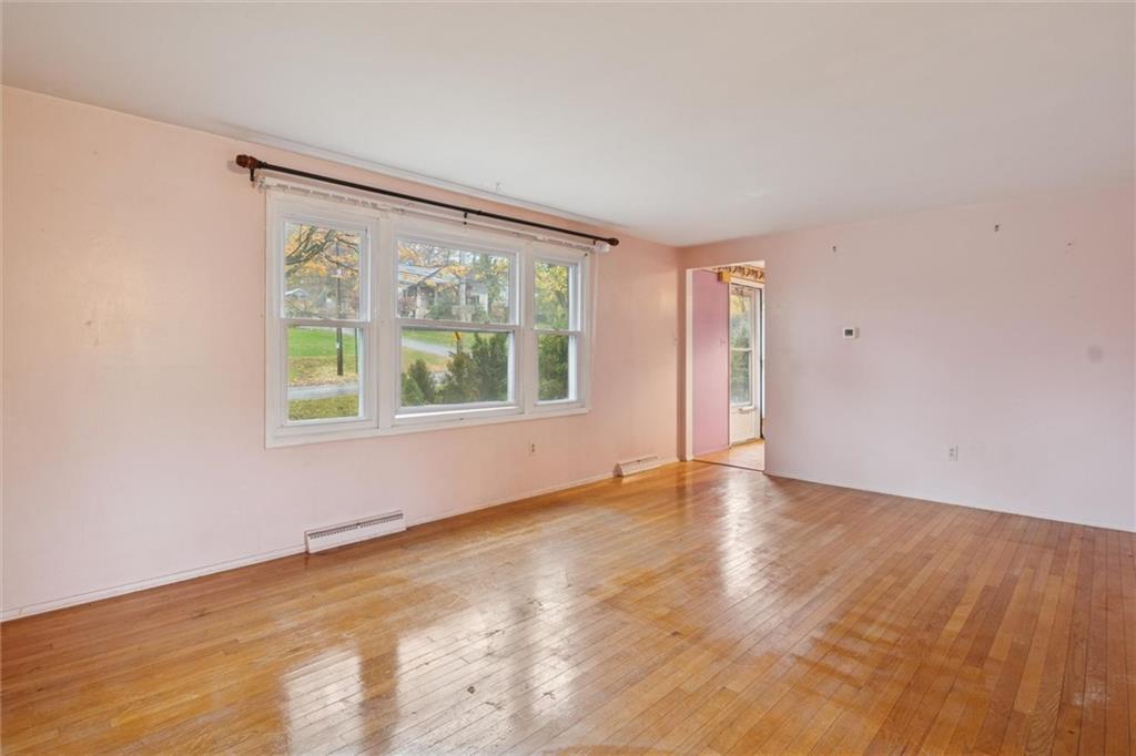 412 Church Road Bethel Park, PA 15102 - Photo 5 of 37 an empty room with wooden floor and windows