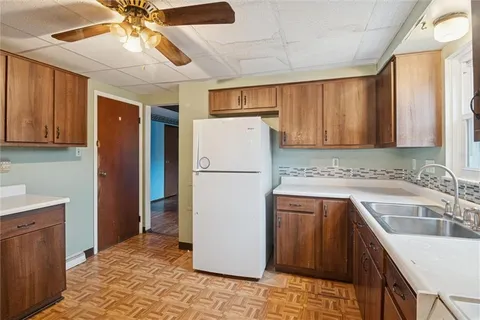 a kitchen with a refrigerator a sink and cabinets