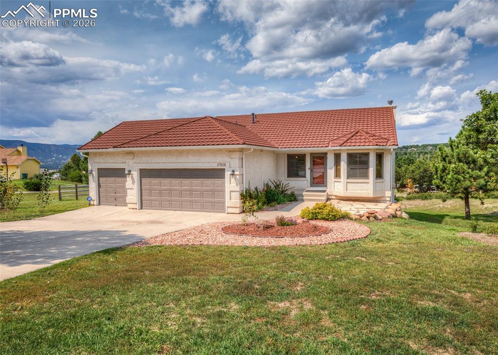 front view of a house with a yard and many windows
