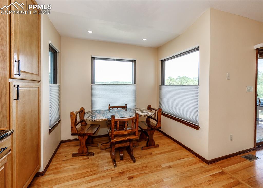 17908 New London Road Monument, CO 80132 - Photo 13 of 41 a dining room with furniture and wooden floor