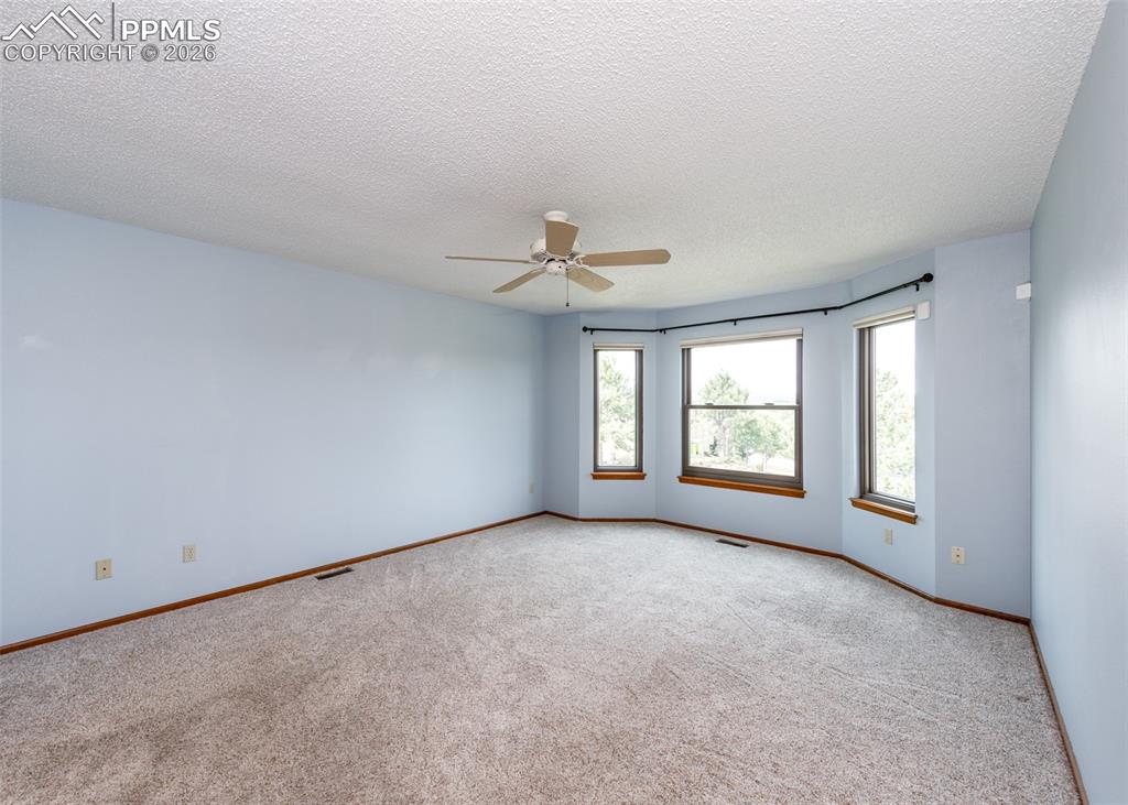 17908 New London Road Monument, CO 80132 - Photo 16 of 41 a view of a livingroom with a ceiling fan and window