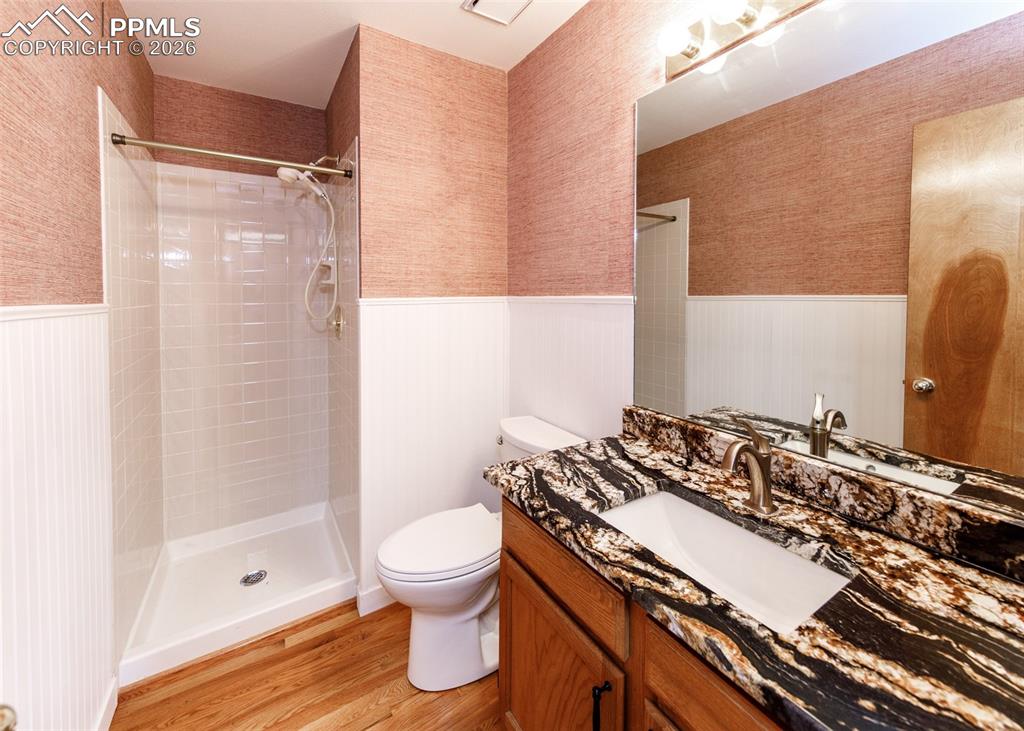 17908 New London Road Monument, CO 80132 - Photo 27 of 41 a bathroom with a granite countertop toilet sink and shower
