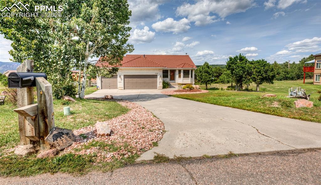 17908 New London Road Monument, CO 80132 - Photo 3 of 41 a view of a patio with a table and chairs under an umbrella