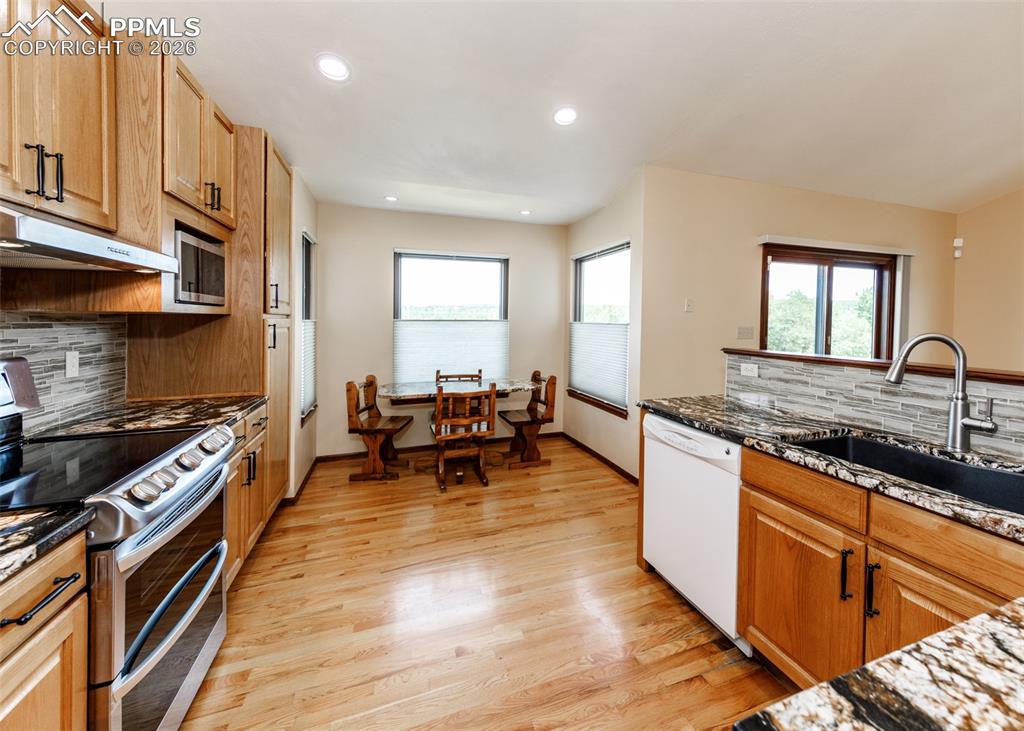 17908 New London Road Monument, CO 80132 - Photo 10 of 41 a kitchen with sink stove and table