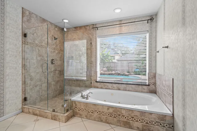 a bathroom with a bathtub and shower