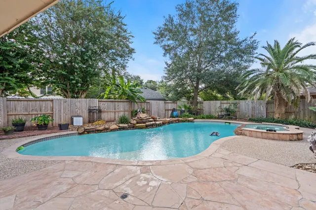 a view of a swimming pool and lounge chair