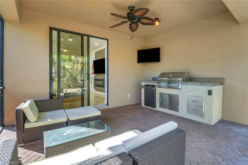 1233 Kendari Terrace Naples, FL 34113 - Photo 19 of 38 a living room with furniture and a fireplace